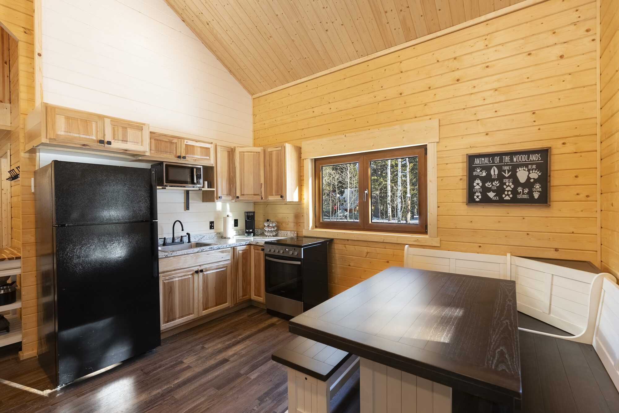 Log cabin kitchen with wood cabinetry and dining nook
