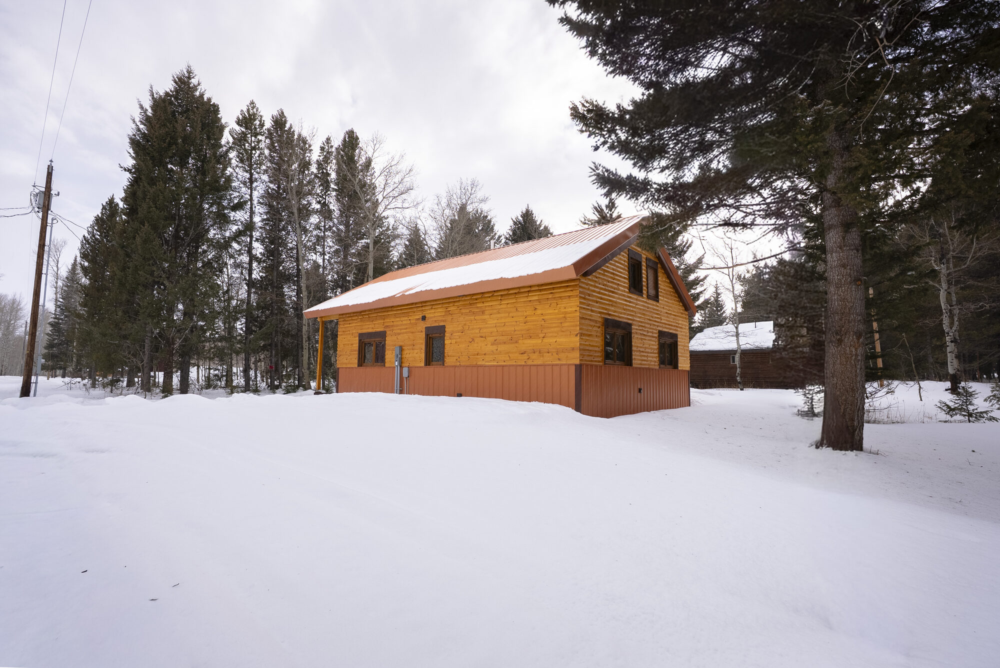 Log cabin exterior in winter, side view