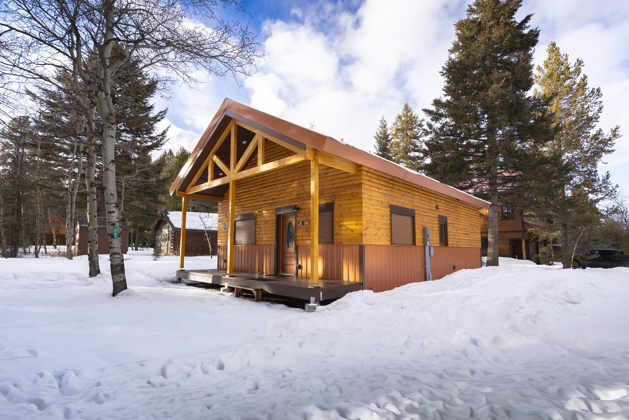 Log cabin exterior in winter, covered front porch